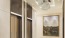 a hallway with a chandelier and elevators
